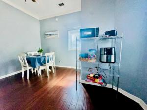 a living room with a table and a dining room at Surf & Strand Unit B in Galveston +28 photos