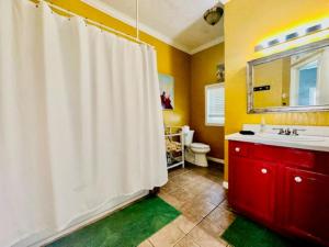 a bathroom with a white shower curtain and a sink at Surf & Strand Unit B in Galveston