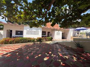 a courtyard of a house with a tree overhead at Brisas de melgar in Melgar
