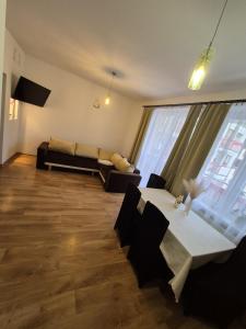 a living room with a table and a couch at Serce Suwałk in Suwałki