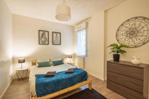 a bedroom with a bed and a window and a dresser at L'escale in Angers