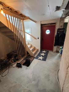 a room with a staircase and a red door at Lake View Villa in Falun
