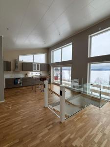 a large room with a glass table and some windows at Lake View Villa in Falun