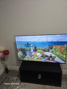 a flat screen tv sitting on top of a dresser at Omos Home in Saskatoon