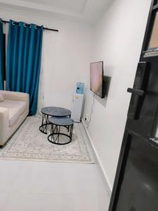 a living room with a table and a couch at Diani Beach Studio with Pool, Beach Access in Diani Beach +7 photos