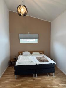 a bedroom with a bed and a window at Lake View Villa in Falun