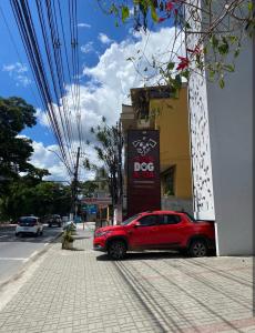 a red car parked on the side of a street at Microcasas in Nova Friburgo
