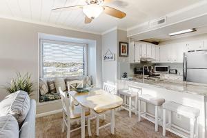 a kitchen and dining room with a table and chairs at ABDV22 Dunescape Villas 236 in Atlantic Beach