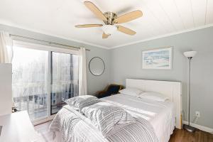 a bedroom with a bed and a ceiling fan at ABDV22 Dunescape Villas 236 in Atlantic Beach