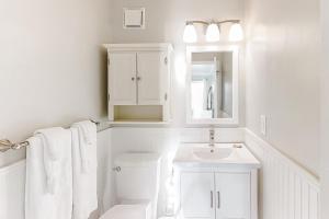a white bathroom with a toilet and a sink at ABDV22 Dunescape Villas 236 in Atlantic Beach +14 photos