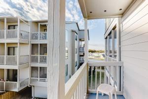 a view from the balcony of a building with a chair at ABDV22 Dunescape Villas 236 in Atlantic Beach
