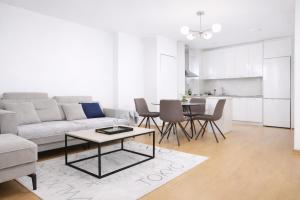 a living room with a couch and a table at Avenoir Suite in Banja Luka