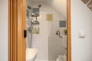 a bathroom with a shower and a sink at Alfama Tiny by Homing in Lisbon
