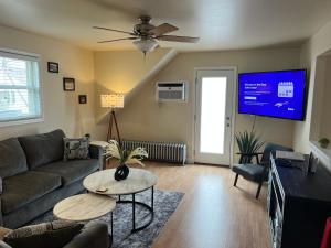 a living room with a couch and a tv at Sexy Suite in Cedarburg