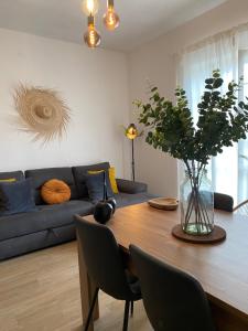 a living room with a table and a blue couch at CasadiCampo in Scauri