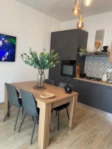 a dining room table with chairs and a kitchen at CasadiCampo in Scauri +87 photos