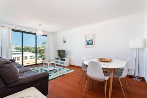 a living room with a couch and a table at Santa Maria Apartamentos in Tavira