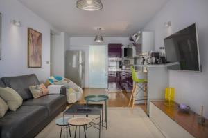 a living room with a couch and a table at Apartments Glusac in Podgora +48 photos