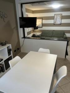 a living room with a couch and a table and chairs at Eporedia Inn in Ivrea