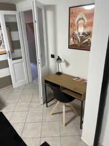 a room with a desk and a room with a bedroom at Eporedia Inn in Ivrea
