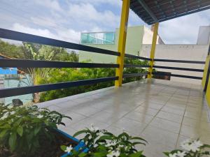 a balcony with a blue and yellow railing at Casa Jambo Canoa Quebrada in Canoa Quebrada +13 photos