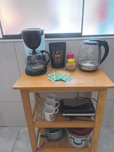 a table with a coffee maker and a blender on it at Amazing views PISAQ in Pisac