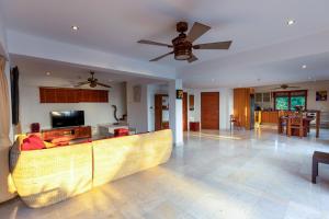 a living room with a couch and a ceiling fan at Villa Vadee - Entire Private Villa, 4 Bedrooms, Large Swimming Pool, Ocean View in Thong Nai Pan Noi