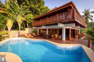 a house with a swimming pool in front of a house at Villa Vadee - Entire Private Villa, 4 Bedrooms, Large Swimming Pool, Ocean View in Thong Nai Pan Noi