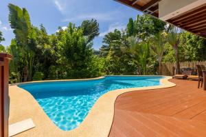 a swimming pool in the backyard of a house at Villa Vadee - Entire Private Villa, 4 Bedrooms, Large Swimming Pool, Ocean View in Thong Nai Pan Noi +47 photos