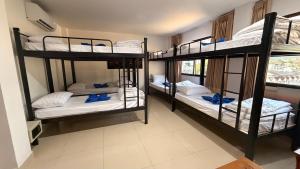 a room with three bunk beds in a room at Luxus Grand Hotel in Patong Beach
