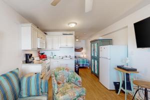 a kitchen and living room with a couch and a refrigerator at ABOS147 Ocean Sands 136 in Atlantic Beach