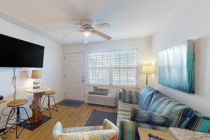 a living room with a couch and a flat screen tv at ABOS147 Ocean Sands 136 in Atlantic Beach