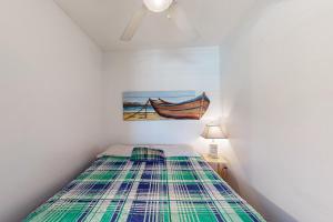 a bedroom with a bed and a painting of a boat at ABOS147 Ocean Sands 136 in Atlantic Beach +31 photos