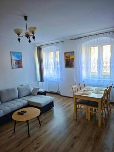 a living room with a couch and a table at Apartament Kris in Wałbrzych