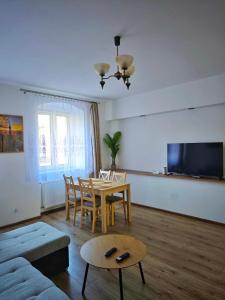a living room with a table and a couch at Apartament Kris in Wałbrzych