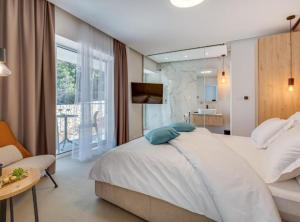 a bedroom with a large white bed and a bathroom at Villa La Bella Vista in Basina +54 photos