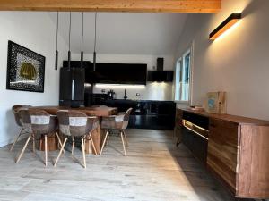 a kitchen with a wooden table and chairs at Villa Goga in Ruta
