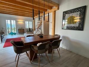 a dining room with a wooden table and chairs at Villa Goga in Ruta
