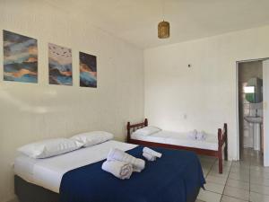 a bedroom with two beds with towels on them at Casa Jambo Canoa Quebrada in Canoa Quebrada
