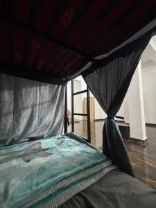 a bed with a canopy in a room at Manavi Home Stay in Mathura +88 photos