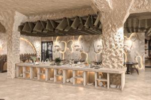 a rendering of a room with a table in a stone wall at Trinity Hotel Banquet & Spa in Siliguri