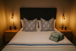 a bedroom with a large white bed with pillows at Seaside tranquility in Gonubie in East London