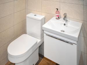 a bathroom with a white toilet and a sink at Lodge 1 - Uk51077 in Lyme Regis