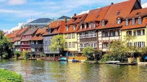 a group of buildings next to a river at FW zur Gemütlichkeit in Hirschaid