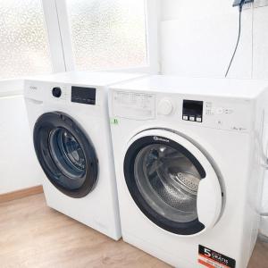 a white washer and dryer in a room at Ferienwohnung AyNa 2, direkt an der Schweizer Grenze in Bad Säckingen