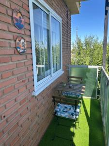 a bench sitting on a porch next to a window at Entrevías in Albacete