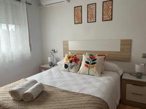 a bedroom with a bed with two towels on it at Entrevías in Albacete