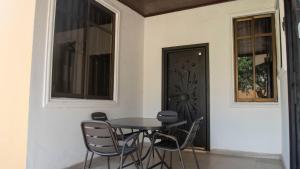 a table and chairs in front of a door at cozyairbnb in Otinshi