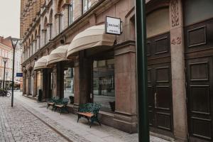 a row of benches sitting outside of a building at Home Hotel Baltzar in Malmö +32 photos
