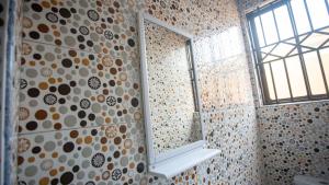 a bathroom with a window and a mirror on a wall at cozyairbnb in Otinshi +17 photos